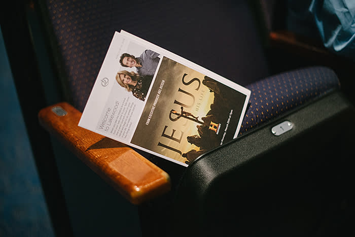 A pamphlet advertising a History Channel TV production about Jesus Christ that Joel Osteen is executive producing, left on a seat in the church