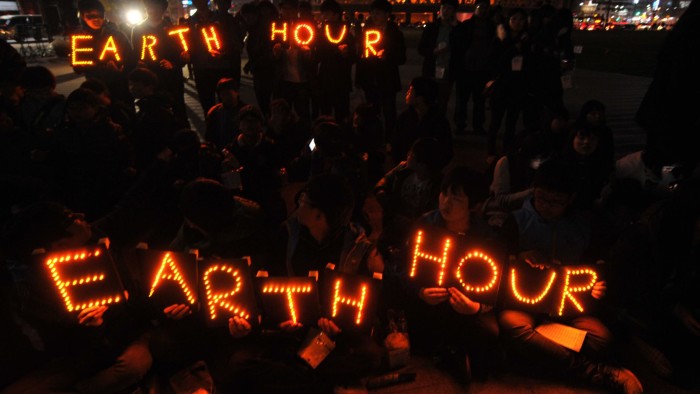 South Korean students hold Earth Hour LED displays during the 7th annual Earth Hour global warming campaign in Seoul on March 23, 2013. One minute brightly lit, the next plunged into darkness -- iconic landmarks around the world will cut their lights on March 23 for the &quot;Earth Hour&quot; campaign against climate change. AFP PHOTO / KIM JAE-HWAN (Photo credit should read KIM JAE-HWAN/AFP/Getty Images)