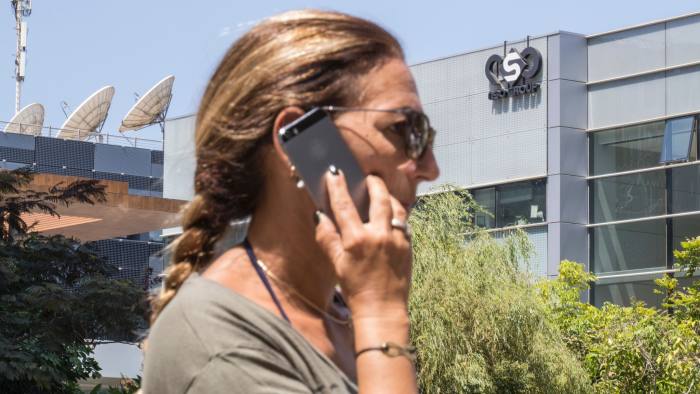 An Israeli woman uses her iPhone in front of the building housing the Israeli NSO group, on August 28, 2016, in Herzliya, near Tel Aviv. Apple iPhone owners, earlier in the week, were urged to install a quickly released security update after a sophisticated attack on an Emirati dissident exposed vulnerabilities targeted by cyber arms dealers. Lookout and Citizen Lab worked with Apple on an iOS patch to defend against what was called "Trident" because of its triad of attack methods, the researchers said in a joint blog post. Trident is used in spyware referred to as Pegasus, which a Citizen Lab investigation showed was made by an Israel-based organization called NSO Group. / AFP / JACK GUEZ (Photo credit should read JACK GUEZ/AFP/Getty Images)
