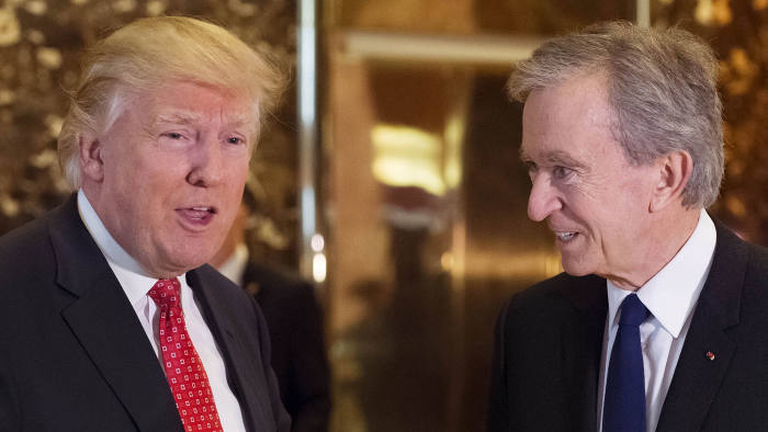 U.S. President-elect Donald Trump, left, and Bernard Arnault, chairman and chief executive officer of LVMH Moet Hennessy Louis Vuitton SA, speak to members of the media in the lobby of Trump Tower in New York, U.S., on Monday, Jan. 8, 2017.