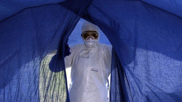 In this Sept. 24, 2014 photo, nurse Dalila Martinez, trainer of the Cuban medical team to travel to Sierra Leone, enters a tent during a practice drill at a training camp, in Havana, Cuba. Cuba's health ministry is sending more than 160 health workers to help stop the raging Ebola outbreak in Sierra Leone in early October. They will stay for six months. (AP Photo/Ladyrene Perez, Cubadebate)