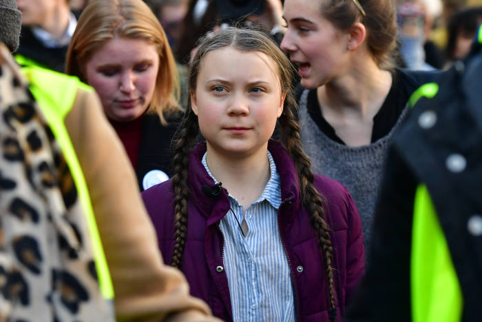 Swedish 16-years-old climate activist Greta Thunberg (C) takes part in a march for the environment and the climate organised by students, in Brussels, on Februaru 21, 2019. - Greta Thunberg, the 16-year-old Swedish climate activist who has inspired pupils worldwide to boycott classes, urged the European Union on February 21, 2019 to double its ambition for greenhouse gas cuts. (Photo by EMMANUEL DUNAND / AFP)        (Photo credit should read EMMANUEL DUNAND/AFP/Getty Images)