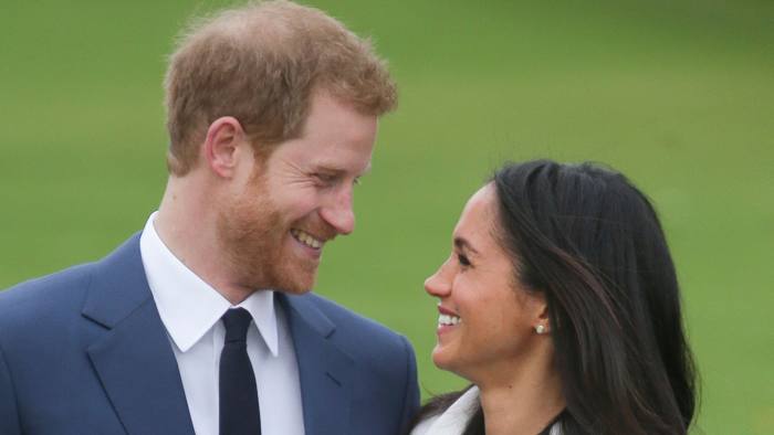 (FILES) In this file photo taken on November 27, 2017 Britain's Prince Harry and his fiancée US actress Meghan Markle pose for a photograph in the Sunken Garden at Kensington Palace in west London on November 27, 2017, following the announcement of their engagement. Prince Harry, who marries US former actress Meghan Markle on May 19, 2018 has been transformed in recent years from an angry young man into one of the British royal family's greatest assets. / AFP PHOTO / Daniel LEAL-OLIVASDANIEL LEAL-OLIVAS/AFP/Getty Images