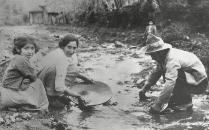 1933 - (Original Caption) Panning For Gold to Solve the Depression! Andacollo, Chile: These Chileans are panning for gold in the neighborhood of the sacred village of Andacollo, near the port of Coquimbo, searching for the gold which the governmnet says will rescue the country from its economic depression. One hundred-thousand jobless, with their families, have been set to work throughout Chile, searching for gold in the scores of streams that flow down to the sea from the snow-clad Andean mountains.