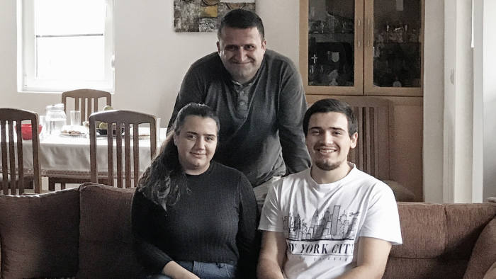 Macedonia seasonal appeal 2018 Habitat for Humanity - Dimce, Nikola, 19 and Gabriela, 18 in their apartment. Roki the parrot is in the cage to the right.