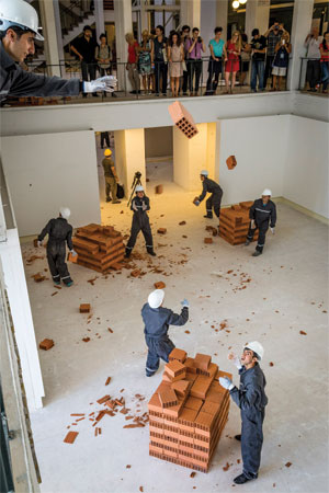 Men throwing bricks from the second floor