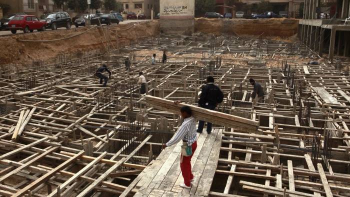 Builders work at a new construction site in Cairo, February 28 2012