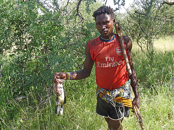 Benja in his prized Arsenal shirt with a hornbill he has caught