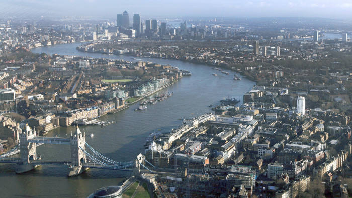Tower Bridge, bottom left, is seen spanning the River Thames, in front of the Canary Wharf business and London's financial district