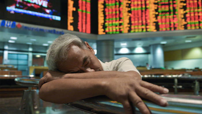 The work catches up with a trader at the Malaysia stock exchange in Kuala Lumpur