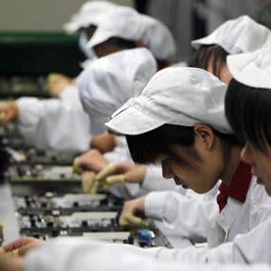 staff members work on the production line at the Foxconn complex in Shenzhen, China