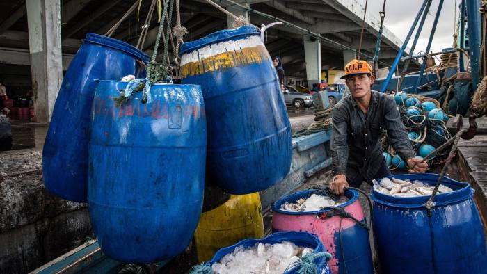 SONGKHLA, THAILAND - FEBRUARY 2: Barrels of fish packed on ice are unloaded from a fishing boat at the port in Songkhla on February 2, 2016. Around 100 people have been arrested by authorities in a recent crackdown on abuses involvingThailand's multi-billion dollar seafood industry. The deep-rooted problem caused the huge global brand, Nestle in 2015 to admit that hat it had discovered clear evidence of slavery at sea in parts of the Thai supply chain. Thailand is the world's third largest exporter of seafood. (Photo by Paula Bronstein/ Getty Images )