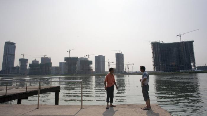 The Conch Bay development stands across the river from the Manhattan-inspired Yujiapu financial district in the Tianjin Binhai New Area CBD of Tianjin, China, on Wednesday, Aug. 10, 2011. A replica of Manhattan, complete with Twin Towers, Lincoln Center and what passes for the Hudson River, is under construction 100 miles (161 kilometers) from Beijing. And like New York City in the 1970s, it may need a bailout. Photographer: Sim Chi Yin/Bloomberg