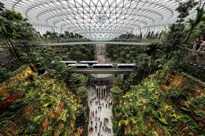 SINGAPORE - APRIL 11: The skytrain rides past the Rain Vortex at the Jewel Changi Airport on April 11, 2019 in Singapore. Officially opening on April 17, Singapore's Changi Airport Jewel includes a 40-meter indoor waterfall contained under a steel-and-glass dome reportedly built for SGD 1.7 billion. (Photo by Suhaimi Abdullah/Getty Images)
