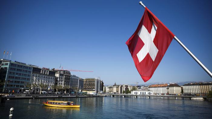 A Swiss national flag flies over Lake Geneva