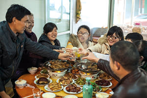 Xiang Ju's family sharing a traditional feast 