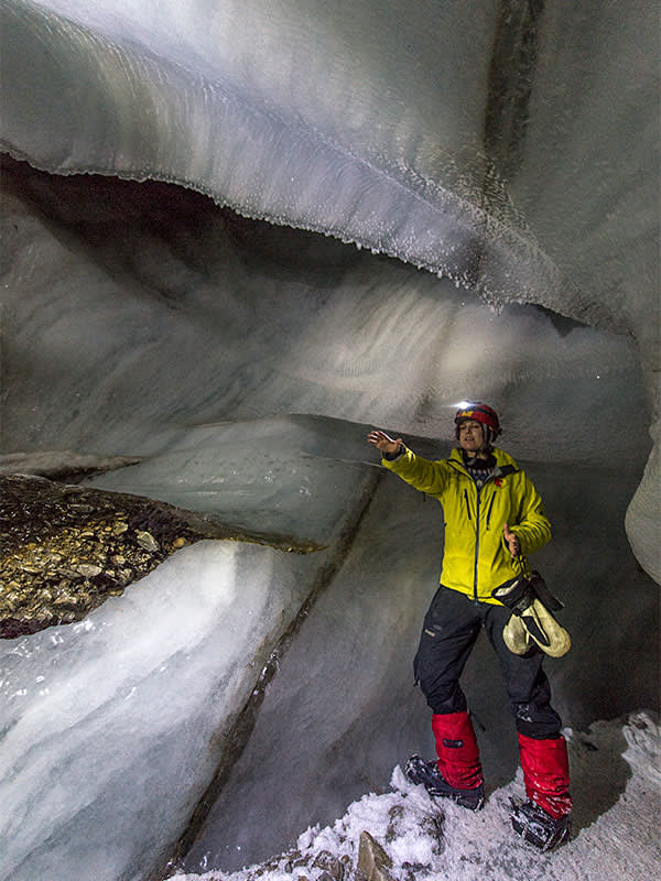 A guide, Signe Dahlberg, inside an ice cave at the Larsbreen Glacier