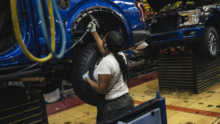 An employee works on the line at the Ford Motor Co. Dearborn Truck Plant in Dearborn, Michigan, U.S., on Thursday, Sept. 27, 2018. Ford Motor Co. is watching trade talks closely. With almost 40 percent of its revenue coming from outside North America and factories in Mexico and Canada, the second-largest U.S. automaker has a lot at stake in the outcomes of the Trump administration's myriad negotiations and tariff schemes. Photographer: Sean Proctor/Bloomberg