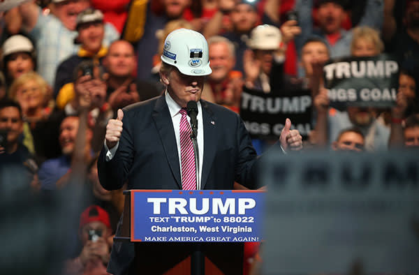 CHARLESTON, WV - MAY 05: Republican Presidential candidate Donald Trump models a hard hat in support of the miners during his rally at the Charleston Civic Center on May 5, 2016 in Charleston, West Virginia. Trump became the Republican presumptive nominee following his landslide win in indiana on Tuesday.(Photo by Mark Lyons/Getty Images)