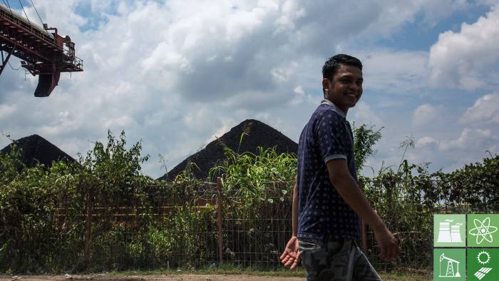 SAMARINDA, INDONESIA - AUGUST 26:  A man walks past a coal stock pile on August 26, 2016 outside Samarinda, East Kalimantan.  Indonesia's East Kalimantan was reported to be one of the worst affected province when coal prices dropped from a high of over USD 127.05 per metric ton in 2011 to the current price of around USD 50 per metric ton in August 2016. Commodity-rich towns in Kalimantan, the world's largest exporter of thermal coal, were hit hard when coal mining companies ceased operations which created a lack of job opportunities and severe social implications, such as an increase in drug abuse and prostitution, as miners found difficulties in finding job opportunities. As the number of unemployment rises in coal mines at parts of Indonesia, both foreign and local workers return home leaving some villages with 50 percent less population leaving abandoned housing and infrastructures while construction sites have been left delayed or cancelled. (Photo by Ed Wray/Getty Images)