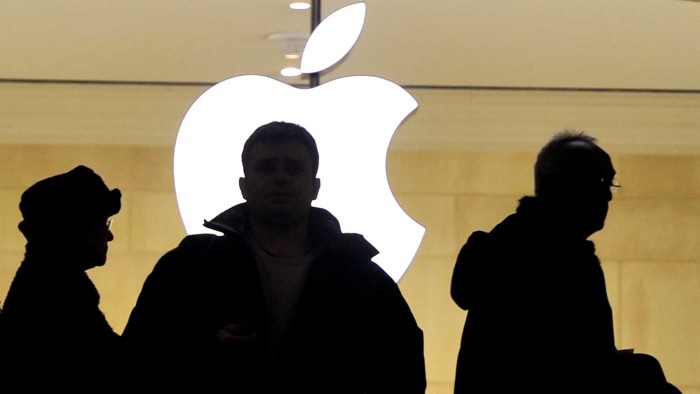 People walk past the Apple logo at the Apple Store at Grand Central Terminal in New York ON January 25, 2013. Apple shares slid about 12 percent on January 24 after the tech giant posted record profits and sales of its iPhones and iPads but offered a disappointing forecast for the coming months.