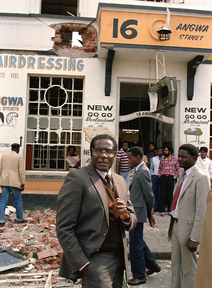 BIO-MUGABE-ANC...Zimbabwe's Prime Minister Robert Mugabe (C) leaves 21 May 1986 the scene of the African National Congress (ANC) offices that were bombed 19 May by a South African commando. ANC led the anti-apartheid struggle in South Africa. Mugabe, Zimbabwean first Premier (in 1980) and President (in 1987), was born in Kutama in 1924 (formerly Southern Rhodesia). Largely self-educated, he became a teacher. After a short periods in the National Democratic Party and Zimbabwe African People's Union (ZAPU) he co-found, in 1963, the Zimbabwe African National Union (ZANU). After a 10-year detention in Rhodesia (1964-74), he spent five years in Mozambique gathering support in preparation for independence in 1980.