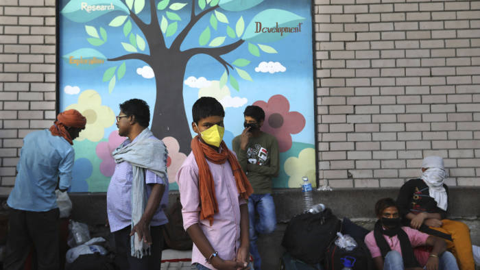 Migrant workers from other states wait in long queue to get his name registered so that they can board a train back to their villages during a nationwide lockdown to curb the spread of new coronavirus in New Delhi, India, Thursday, May 21, 2020. India's lockdown was imposed on March 25 and has been extended several times. On May 4, India eased lockdown rules and allowed migrant workers to travel back to their homes, a decision that has resulted in millions of people being on the move for the last two weeks. (AP Photo/Manish Swarup)