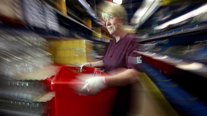 An employee handles a box at the Ocado Ltd. distribution center in Hatfield, UK., on Wednesday, June 16, 2010. Ocado, the U.K. online grocer, will offer shares to customers in the event that it proceeds with plans for an initial public offering in London. Photographer: Jason Alden/Bloomberg