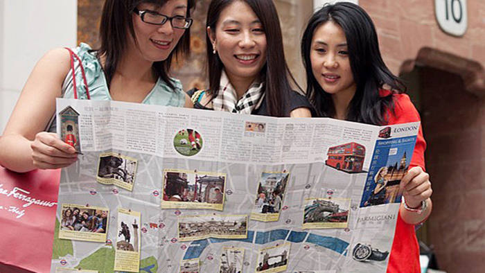 Chinese tourists view the Eastsong map of luxury London shopping destinations