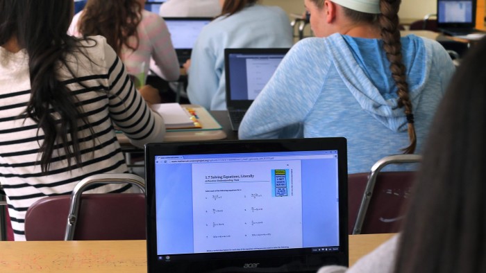 Students work on a math equation using Chromebooks at Milton High School