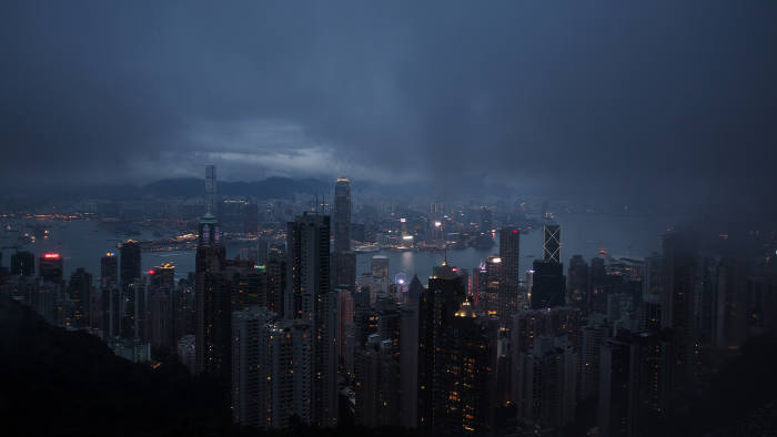 Illuminated buildings shrouded in haze are seen from Victoria Peak at dusk in Hong Kong, China, on Friday, Jan. 22, 2016