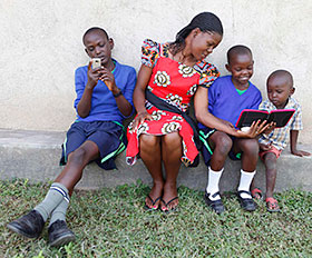 A teacher and pupils in Kisumu, Kenya