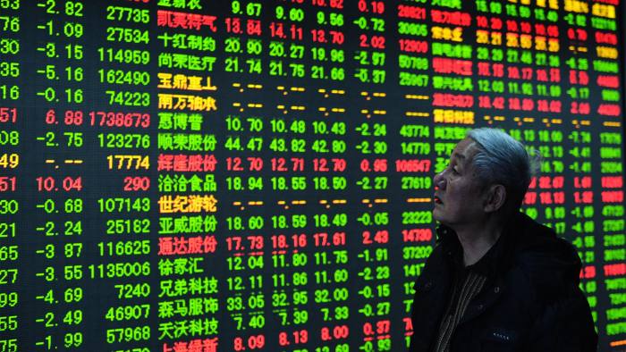 CHINA, HANGZHOU : A stock investor checks the share prices at a security firm in Hangzhou, east China's Zhejiang province on December 30, 2014. China's stock market is set to finish 2014 as the second-best performer in the world after soaring by almost 50 percent in a borrowing-fuelled, government-backed rally following four years in the doldrums. CHINA OUT AFP PHOTO