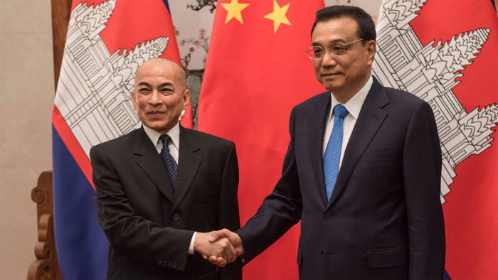 China's Premier Li Keqiang (right) shakes the hand of Cambodia's King Norodom Sihamoni at the Great Hall of the People in Beijing on June 3 2016