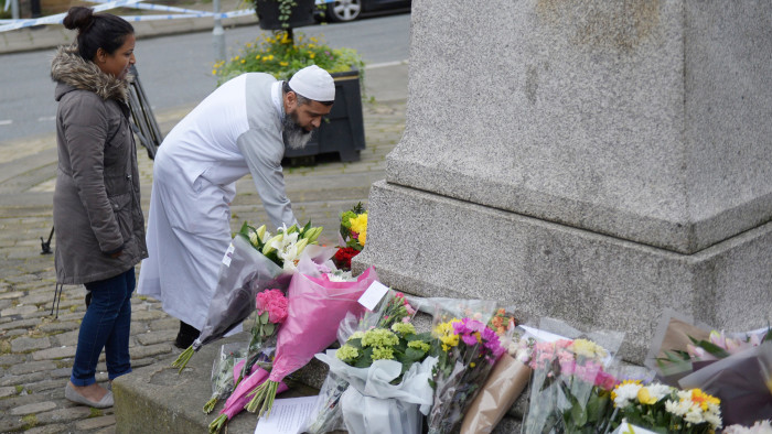 A man arrives to lay floweres at a statue to Joseph Priestly in Birstall, northern England, on June 17, 2016, near to the scene where Labour MP Jo Cox was shot yesterday. Jo Cox, the British lawmaker murdered on the streets of northern England on June 16, had complained to police earlier this year about &quot;malicious communications&quot; she received, police said Friday. / AFP PHOTO / OLI SCARFFOLI SCARFF/AFP/Getty Images