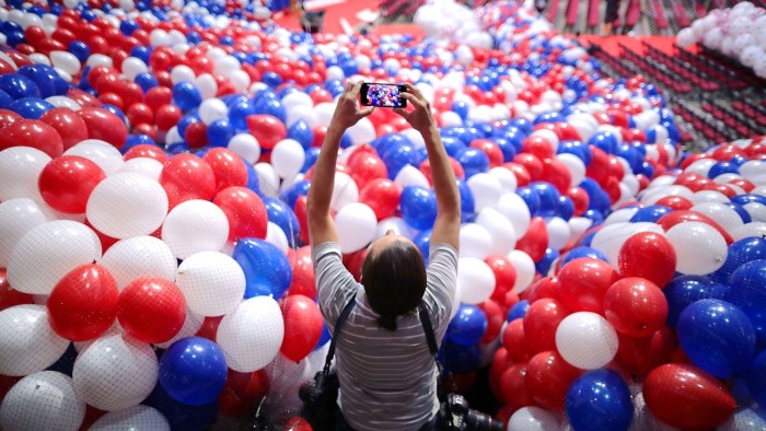 CLEVELAND, OH - JULY 15:  A news photographer makes images of nets filled with thousands of red, white and blue balloons before they are lifted into the ceiling of the Quicken Loans Arena July 15, 2016 in Cleveland, Ohio.The Republican National Convention is scheduled to begin on Monday.  (Photo by Chip Somodevilla/Getty Images)