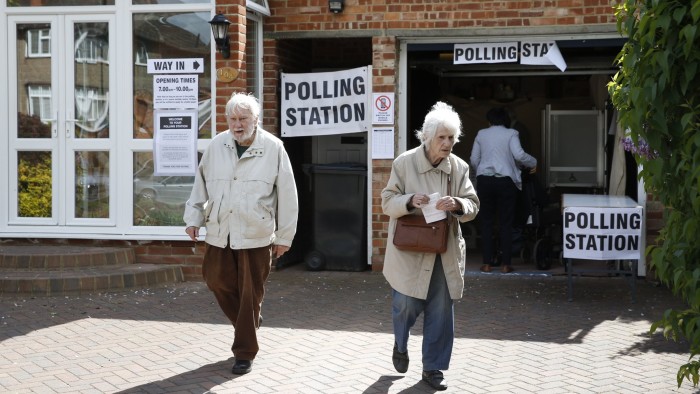 Members of the public vote at a polling station set up in the garage of a house in Croydon on May 7, 2015, as Britain holds a general election. Polls opened today in Britain's closest general election for decades with voters set to decide between the Conservatives of Prime Minister David Cameron, Ed Miliband's Labour and a host of smaller parties. AFP PHOTO / ADRIAN DENNIS (Photo credit should read ADRIAN DENNIS,ADRIAN DENNIS/AFP/Getty Images)