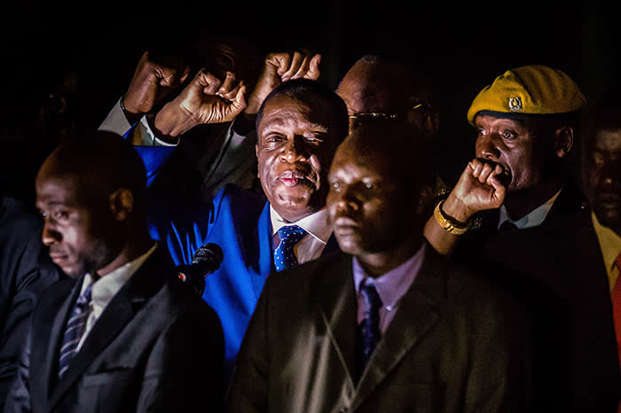 TOPSHOT - Zimbabwe's incoming President Emmerson Mnangagwa (2nd L) gestures as he speaks to supporters at Zimbabwe's ruling Zanu-PF party headquarters in Harare on November 22, 2017. Zimbabwe's former vice president Emmerson Mnangagwa flew home on November 22 to take power after the resignation of Robert Mugabe put an end to 37 years of authoritarian rule. Mnangagwa will be sworn in as president at an inauguration ceremony on November 24, officials said. / AFP PHOTO / Jekesai NJIKIZANAJEKESAI NJIKIZANA/AFP/Getty Images