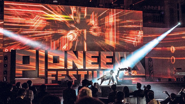a dancing robot on stage at the Pioneers Festival