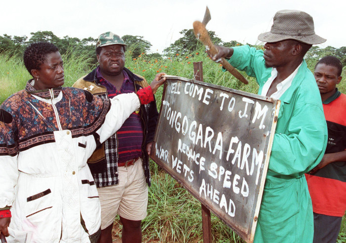 ZIMBABWE - MARCH 15: Independance war veterans rename Parklands Farm, 25 kilometers south west of the capital Harare 15 March 2000 after liberation war hero Josiah Tongogara. There has been resurgence of invasions of white owned farms by Zimbabwe's independance war veterans and only President Robert Mugabe can put a stop to them. (Photo credit should read PAUL CADENHEAD/AFP/Getty Images)