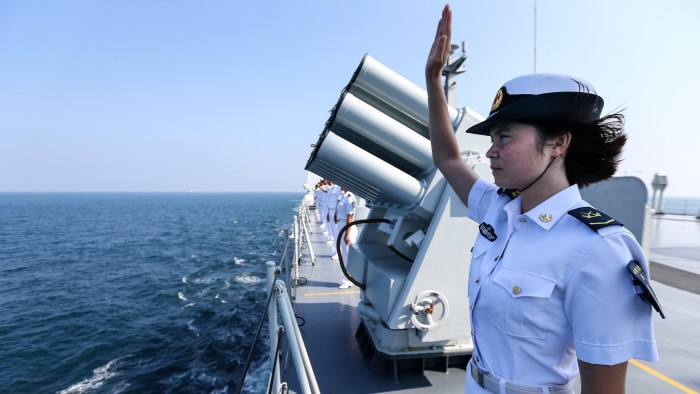 A Chinese soldier waves farewell to Russian fleets as the Chinese-Russian joint naval drill concludes in Zhanjiang, Guangdong Province, China, September 19, 2016. REUTERS/Stringer ATTENTION EDITORS - THIS IMAGE WAS PROVIDED BY A THIRD PARTY. EDITORIAL USE ONLY. CHINA OUT. NO COMMERCIAL OR EDITORIAL SALES IN CHINA. - RTSOJ3R
