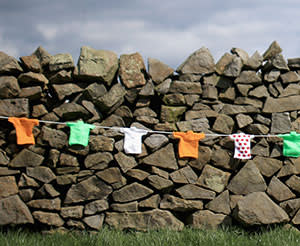 A dry stone wall in Harrogate decorated with miniature Tour jerseys