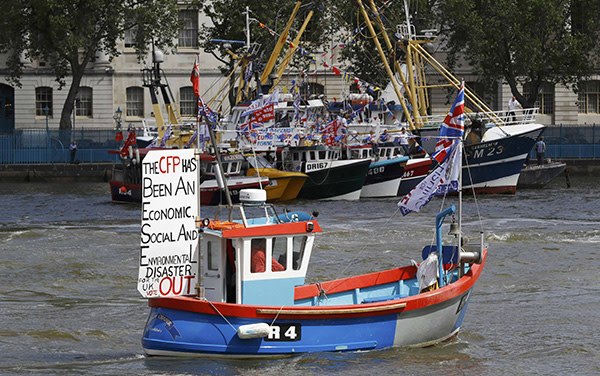 A boat forming part of a flotilla of fishing vessels campaigning to leave the European Union sails up the river Thames in London, Britain June 15, 2016. REUTERS/Stefan Wermuth