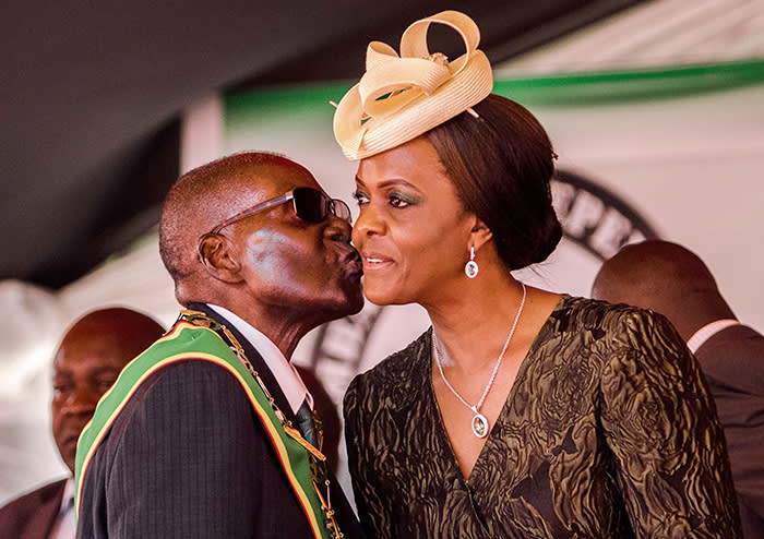 President Robert Mugabe kisses his wife and first lady Grace Mugabe during during the country's 37th Independence Day celebrations at the National Sports Stadium in Harare April 18, 2017. / AFP PHOTO / Jekesai NJIKIZANA (Photo credit should read JEKESAI NJIKIZANA/AFP/Getty Images)