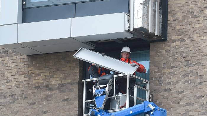 Workers remove panels of external cladding from the facade of a building in the Wythenshawe area of Manchester, northwest England, on June 25, 2017. The Wythenshawe Community Housing Group (WCHG) which run the development the building is part of took the decision, announced in a June 22 statement, to remove 78 feature panels of external cladding from the development after fire safety tests in the wake of the Grenfell Tower fire. Some 34 high-rise buildings in 17 local authorities in England have already failed urgent fire tests conducted after Grenfell, the government announced June 24, raising fears that thousands more may need to leave their homes. / AFP PHOTO / PAUL ELLISPAUL ELLIS/AFP/Getty Images