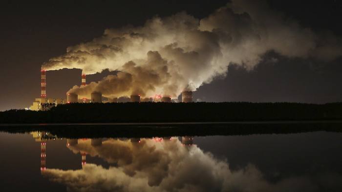 FILE - In this Wednesday, Nov. 28, 2018 file photo, plumes of smoke rise from Europe's largest lignite power plant in Belchatow, central Poland. As politicians haggle at a U.N. climate conference in Poland over ways to limit global warming, the industries and machines powering our modern world keep spewing their pollution into the air and water. The fossil fuels extracted from beneath the earth‚Äôs crust _ coal, oil and gas _ are transformed into the carbon dioxide that is now heating the earth faster than scientists had expected even a few years ago. (AP Photo/Czarek Sokolowski)