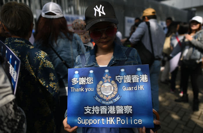 A supporter of the Hong Kong Police Force holds a placard while participating in a pro-law enforcement rally outside the Legislative Council building in Hong Kong on November 16, 2019. - China's President Xi Jinping warned November 14 that protests in Hong Kong threaten the "one country, two systems" principle governing the semi-autonomous city that has tipped into worsening violence with two dead in a week. (Photo by Ye Aung THU / AFP) (Photo by YE AUNG THU/AFP via Getty Images)