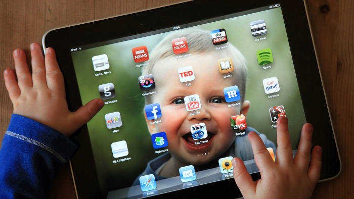 In this photo illustration a 13-month old baby uses a iPad at his home on November 25, 2011 in Glastonbury, United Kingdom