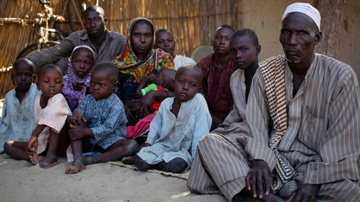 A matter of pride: Malngaye Adam, right, with his wife Kattouma and their 10 children in the village of Tagal in the Lake Chad basin