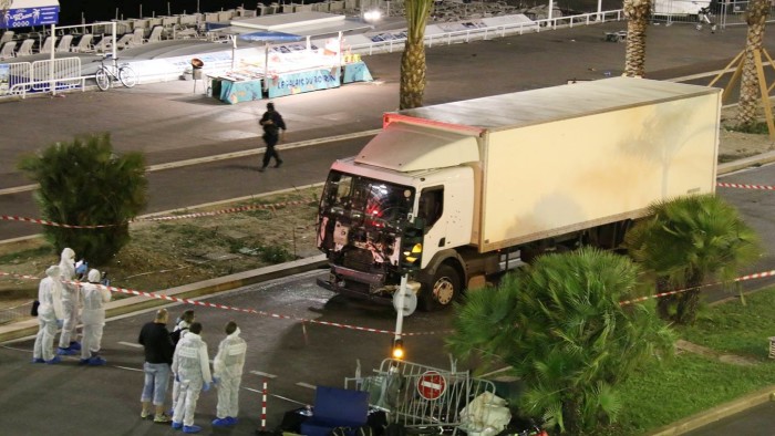 Authorities investigate a truck after it plowed through Bastille Day revelers in the French resort city of Nice, France, Thursday, July 14, 2016. France was ravaged by its third attack in two years when a large white truck mowed through revelers gathered for Bastille Day fireworks in Nice, killing at dozens of people as it bore down on the crowd for more than a mile along the Riviera city's famed seaside promenade. (Sasha Goldsmith via AP)